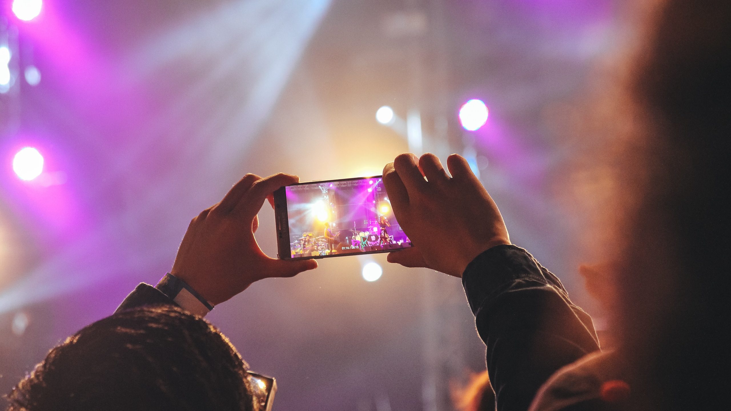 hand-hold-smart-phone-taking-photo-recording-video-concert-stage